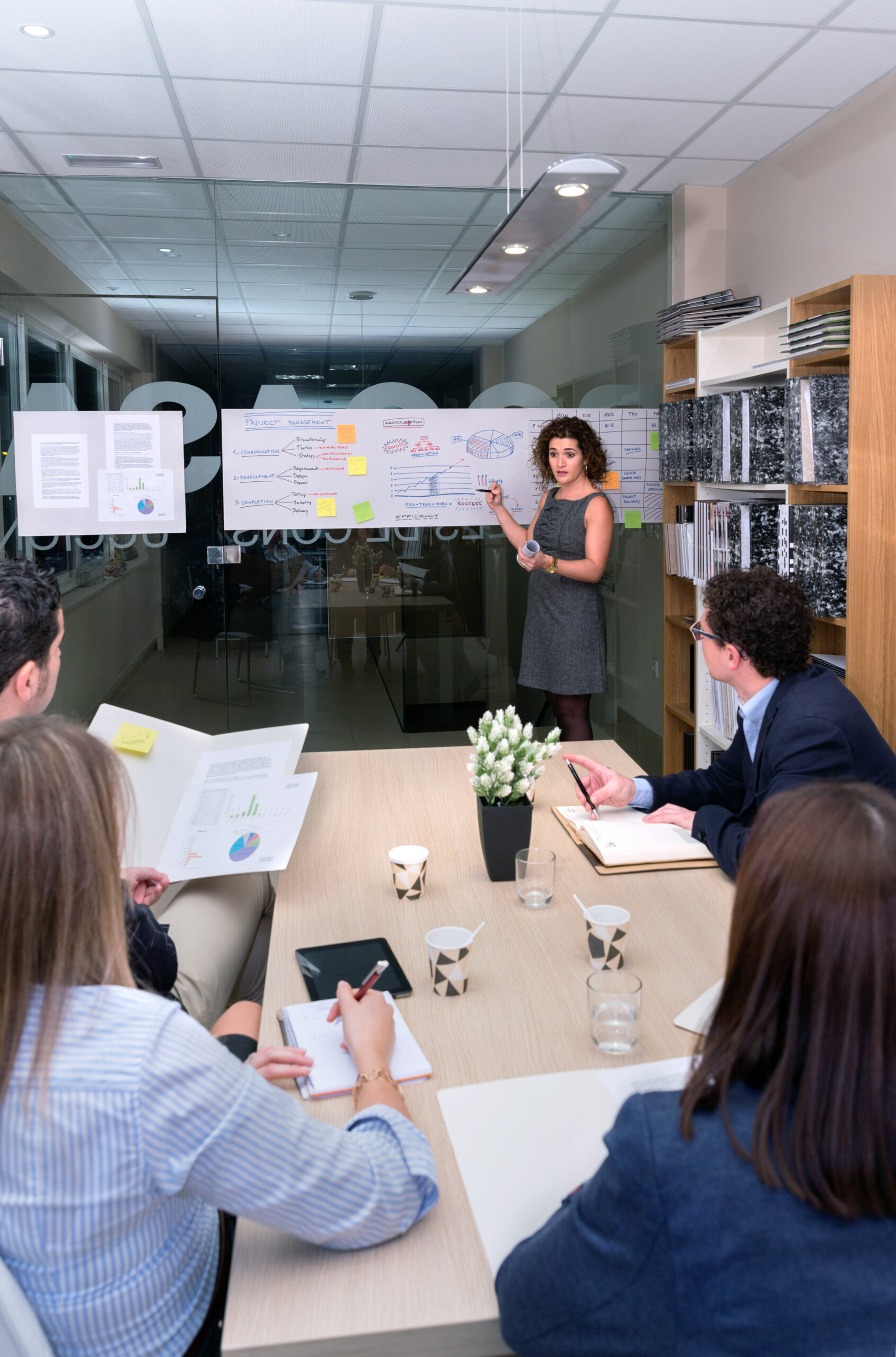 Female coach training business team at headquarters